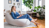 moon pod with woman reclining on it in a hygge background