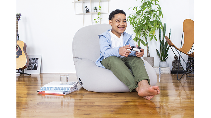 child playing video games seated on moon pod