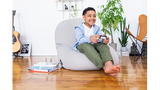 child playing video games seated on moon pod